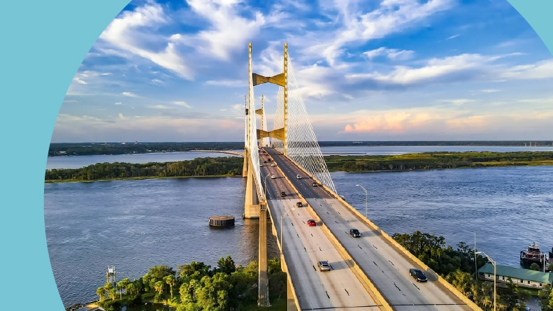 Aerial view of Jacksonville’s iconic suspension bridge at sunset.