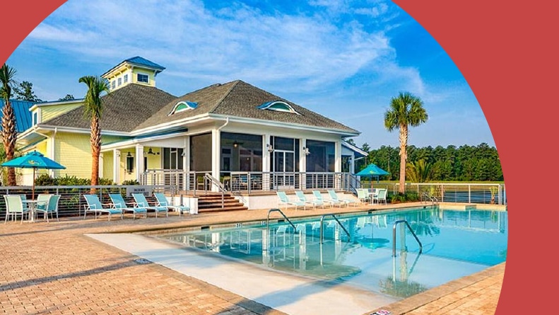 Lounge chairs and palm trees beside an outdoor pool at Latitude Margaritaville Hilton Head in Hardeeville, South Carolina.