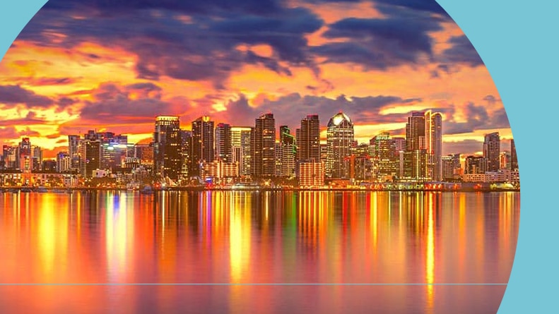 View across the water of the San Diego skyline at sunset.