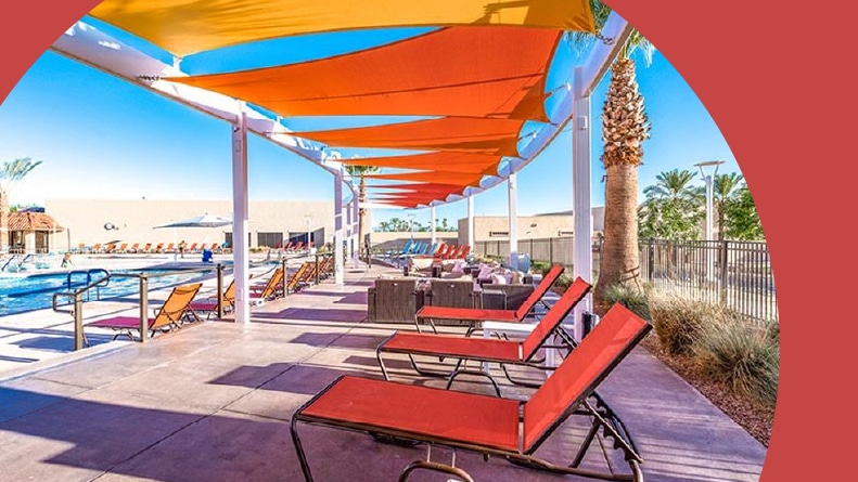 Lounge chairs beside the outdoor pool at Sun City West in Sun City West, Arizona.