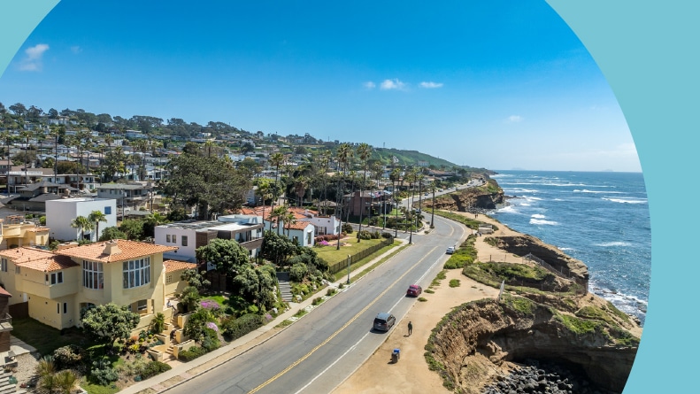 Aerial view of hillside luxury homes above Sunset Beach in San Diego on a sunny day.