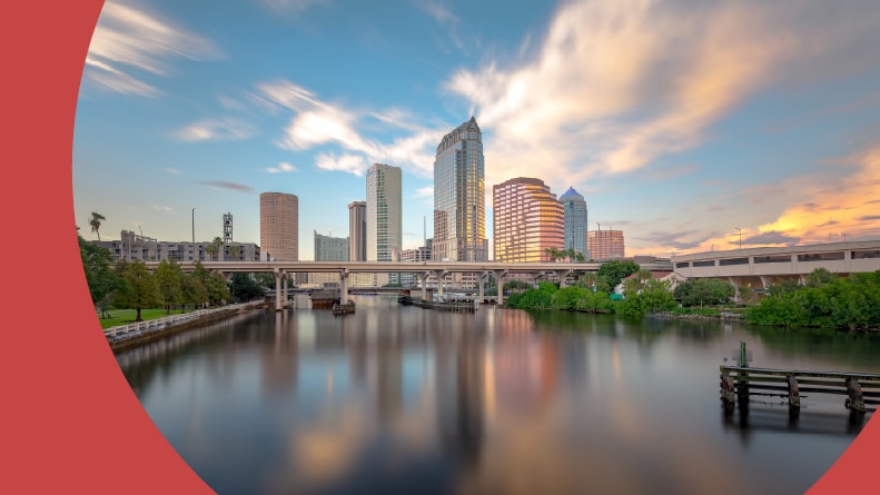 View across the water of the skyline in Tampa, Florida at sunset.