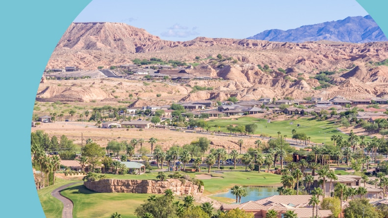 Aerial view of Mesquite, Nevada nestled in a valley among mesas and mountains.