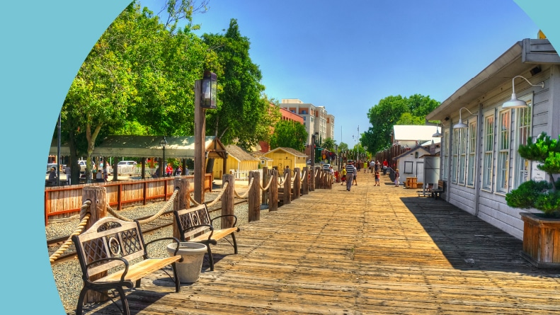 Benches along a boardwalk in Sacramento, California on a sunny day.
