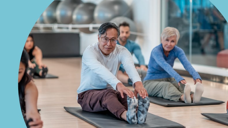 A group of 55+ adults taking a yoga class in their community.