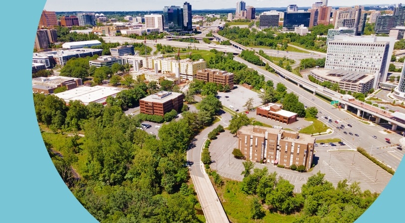 Aerial view of green streets and modern buildings in Tysons Corner in Fairfax County, Virginia.