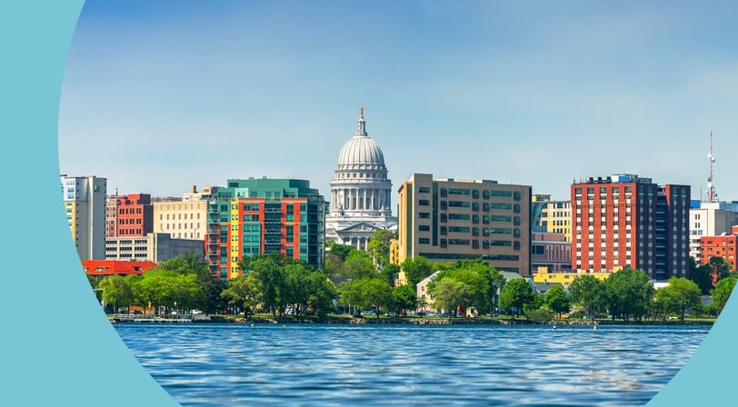 The downtown skyline of Madison, Wisconsin on Lake Monona in the daytime.