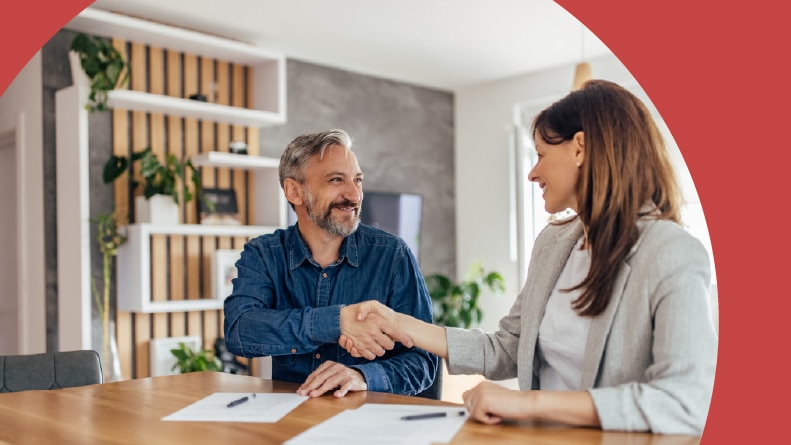 A happy client buying a new apartment from a real estate agent.