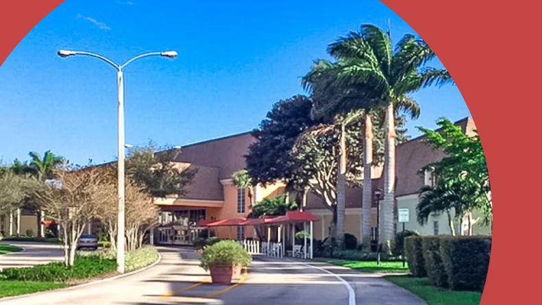 Palm trees lining a street in Kings Point in Delray Beach in Delray Beach, Florida.