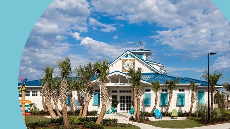 Palm trees surrounding a club house at Latitude Margaritaville Watersound in Panama City Beach, Florida.