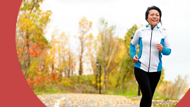 An active adult woman jogging along a path in her 55+ community.