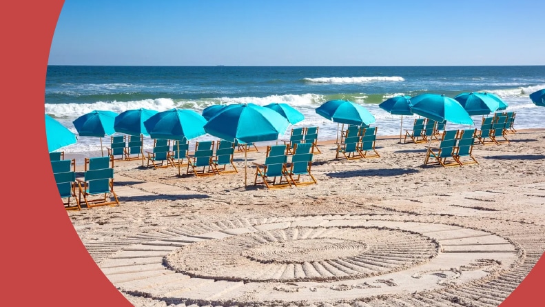 Lounge chairs and beach umbrellas along the private beach at Latitude Margaritaville in Daytona Beach, Florida.