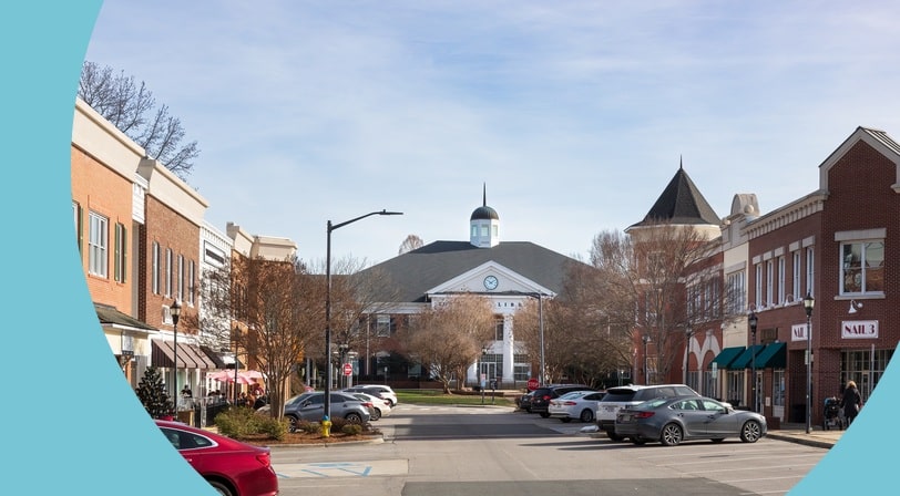 Street view of Matthews Station, the town hall, the library, and commercial businesses in Matthews, North Carolina.