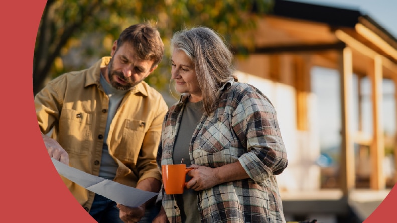 A 55+ couple having a coffee break while working together on a DIY house project.