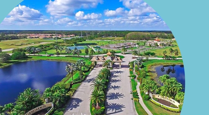 Aerial view of the community entrance at Cascades at River Hall, a 55+ community in Alva, Florida.