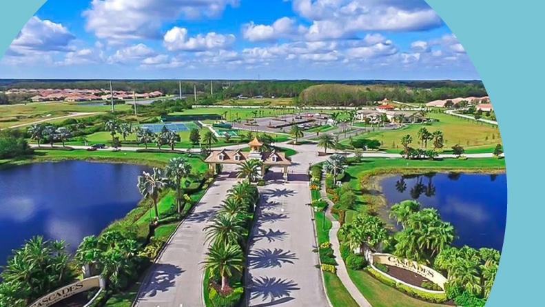Aerial view of the entrance to Cascades at River Hall, a 55+ community in Alva, Florida.