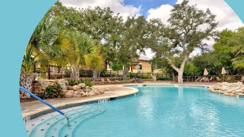 Trees surrounding the outdoor pool at Hill Country Retreat in San Antonio, Texas.