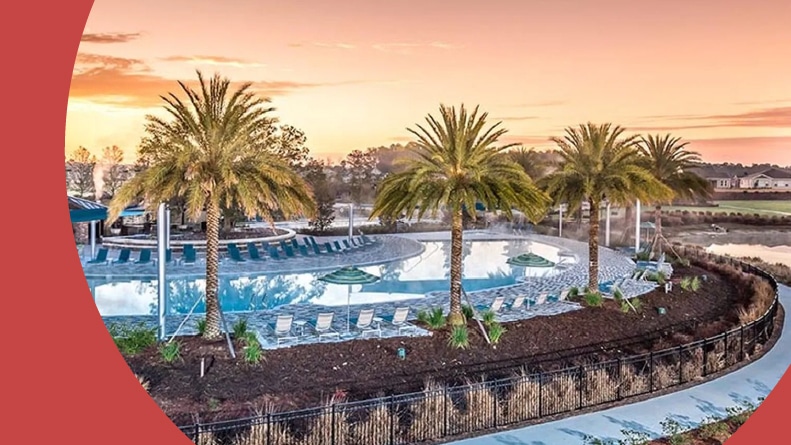 Palm trees and lounge chairs beside the outdoor pool at Ocala Preserve, a 55+ community in Ocala, Florida.