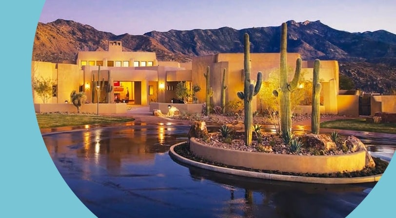 Clubhouse at dusk with mountain views at SaddleBrooke, a 55+ community in Tucson, Arizona.