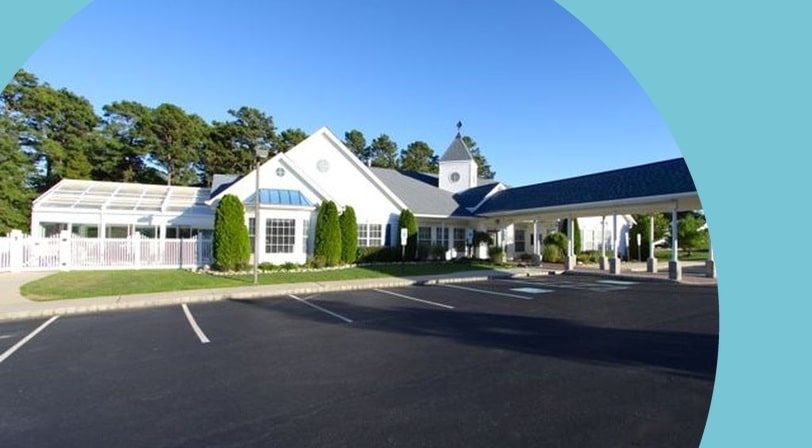 Clubhouse exterior and parking area at Sunrise Bay, a 55+ community in Little Egg Harbor, New Jersey.