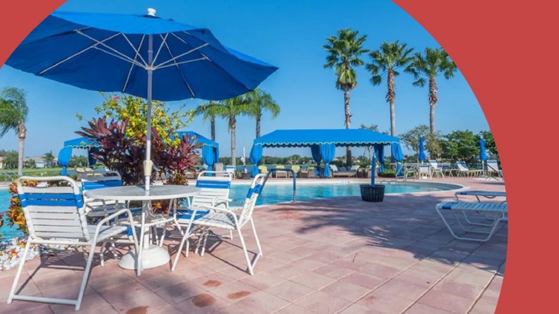 Lounge chairs beside the outdoor pool at Valencia Lakes, a 55+ community in Wimauma, Florida.