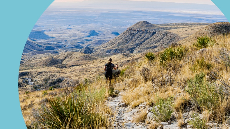 A female hiker on The El Capitan Trail at sunrise in Guadalupe Mountains National Park in West Texas.