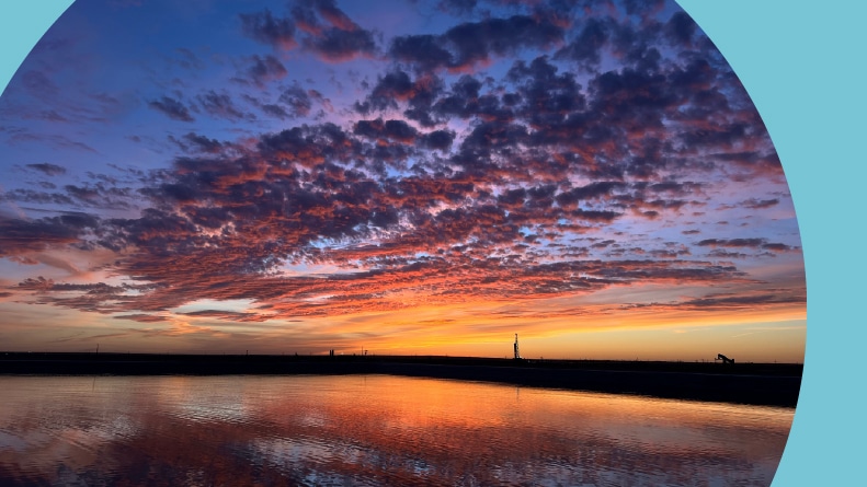 A sunset over a West Texas oilfield.