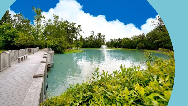 A boardwalk over a pond on the grounds of Windsor Lakes in The Woodlands, Texas.