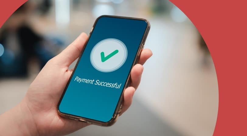 Mobile phone screen showing a circle with a green check and payment successful.