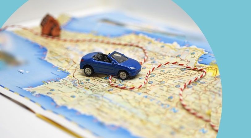Toy car following a string path on a map.