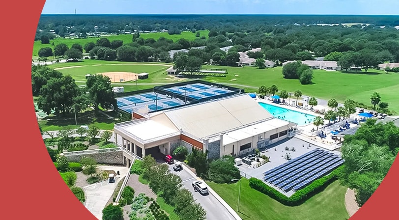 Aerial view of a clubhouse and the amenities at On Top of the World, a 55+ community in Ocala, Florida.