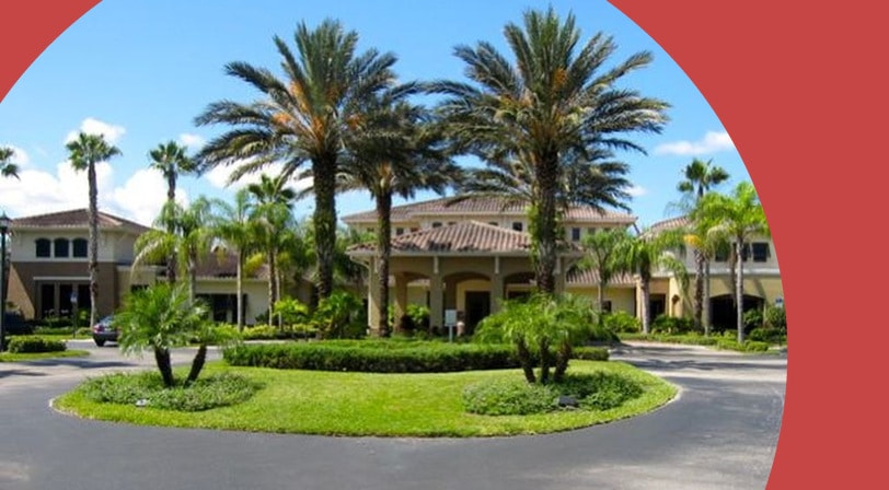 Palm trees beside the entrance to Kings Point, a 55+ community in Sun City Center, Florida.