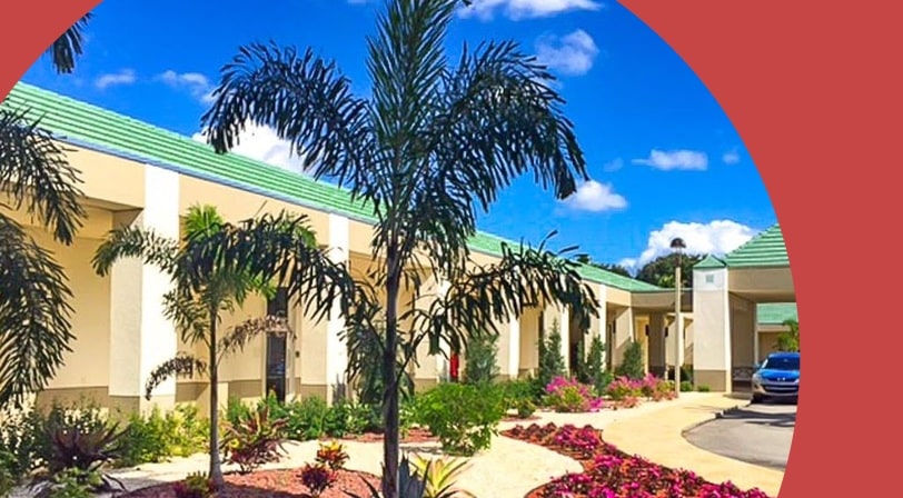 Palm trees beside the entrance of Wynmoor Village, a 55+ community in Coconut Creek, Florida.