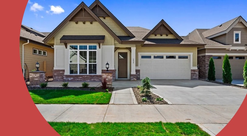 A single-story craftsman-style home with a two-car garage, brick accents, and a manicured front lawn on a sunny day.