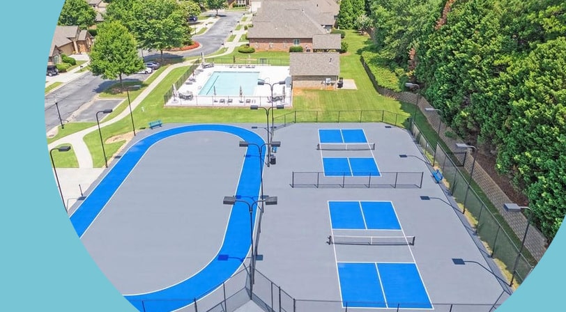 An aerial view of the pool and pickleball courts at Magnolia Village, a 55+ community in Sugar Hill, Georgia.