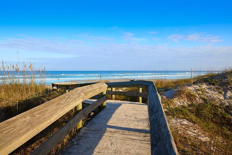 A boardwalk leading to Atlantic Beach in Jacksonville, Florida on a sunny day.