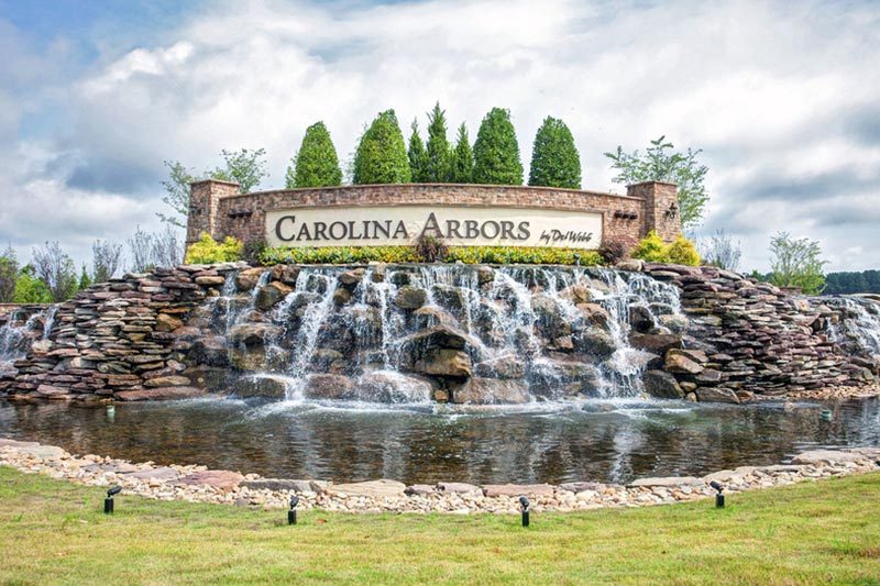 A waterfall beneath the community sign for Carolina Arbors in Durham, North Carolina.