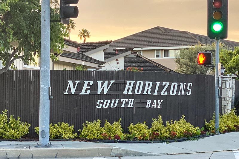 The community sign at the entrance of New Horizons South Bay in Torrance, California.