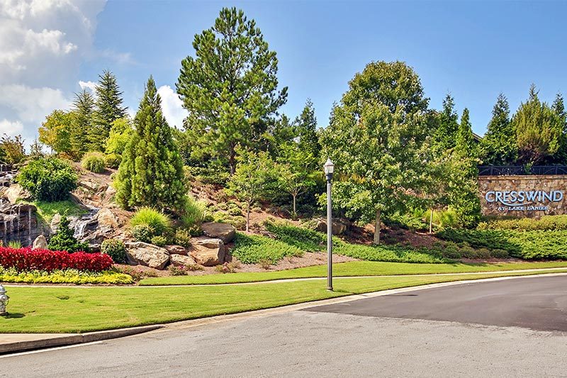 Trees beside the welcome sign at the entrance to Cresswind at Lake Lanier, a 55+ community in Gainesville, Georgia.