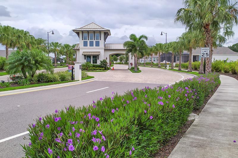four-seasons-at-orlando-kissimmee-florida Greenery surrounding the entrance of Four Seasons at Orlando, a 55+ community in Kissimmee, Florida.
