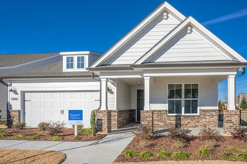 Exterior view of a model home at Del Webb Carolina Gardens, Fuquay-Varina, North Carolina on a sunny day.