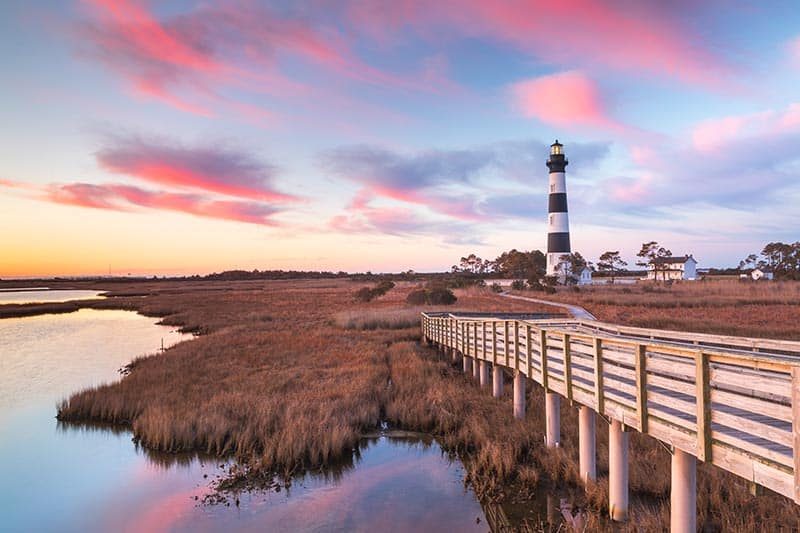 Sunset over the marsh and lighthouse on Bodie Island on the Outer Banks of North Carolina.