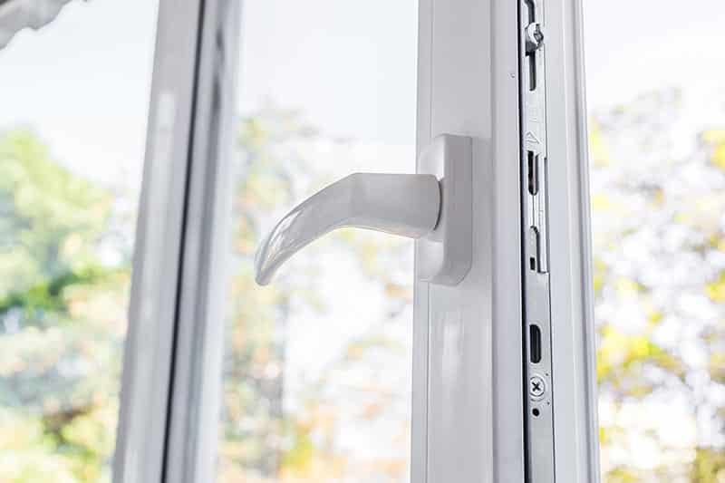 A white handle on a glass door on a house in a 55+ community.