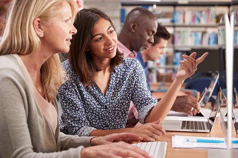 mature-female-student-tutor-learning-computer-skills