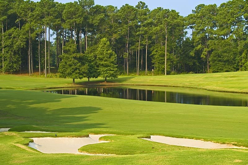 View of a pond and some sand traps on a Myrtle Beach golf course.