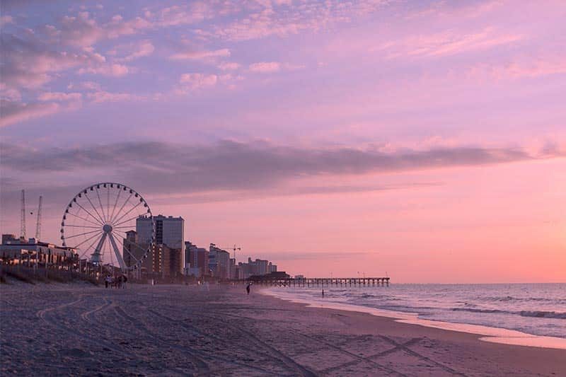View along the beach of Myrtle Beach, South Carolina at sunrise.