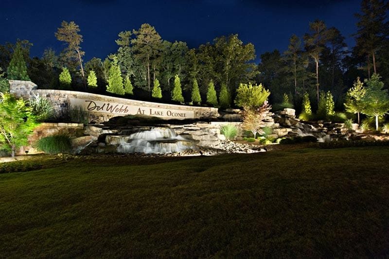 The entrance sign lit at night at Del Webb at Lake Oconee, a 55+ community Greensboro, Georgia.