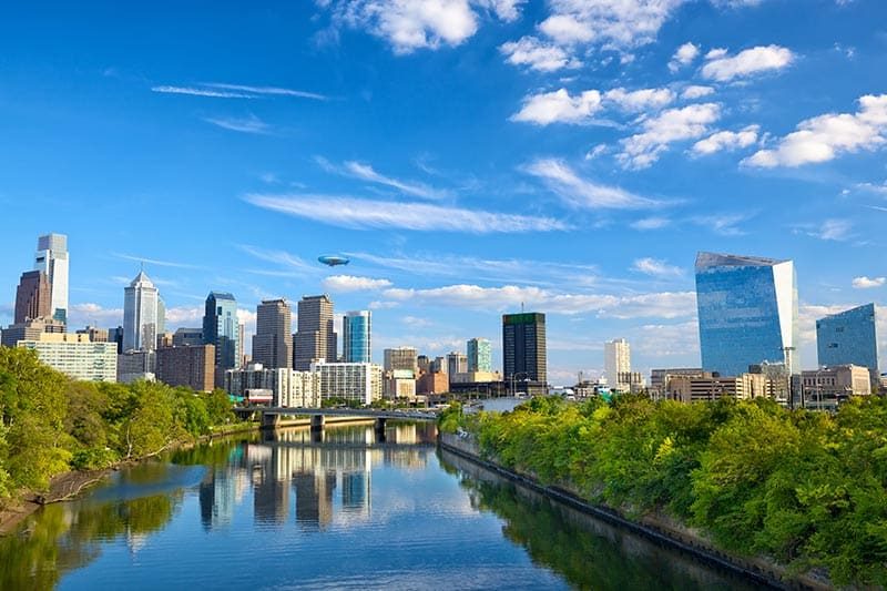 View of the Downtown Philadelphia skyline from across the Schuylkill River on a sunny day.