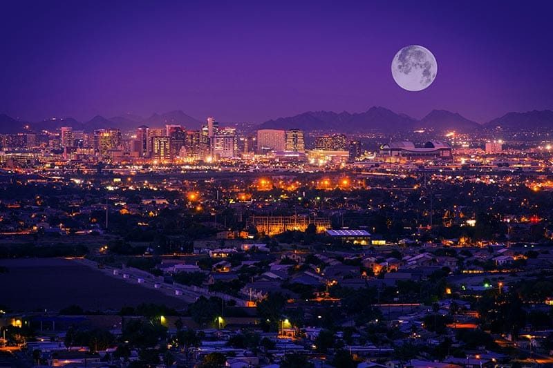 A full moon over the downtown skyline of Phoenix, Arizona.