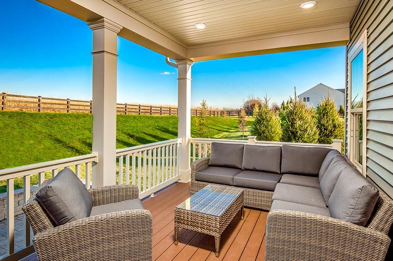 Lounge furniture on the porch of a home at The Woodlands of Urbana in Urbana, Maryland.